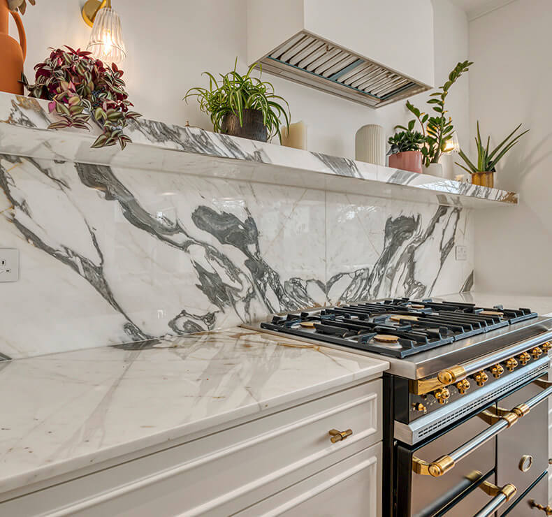 Modern domestic kitchen interior design in a room with light taupe, kitchen countertop with a cooker.