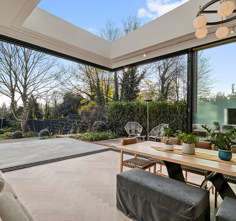 Modern domestic room with light grey and dark brown wood table, chairs, window, flooring, and architecture materials