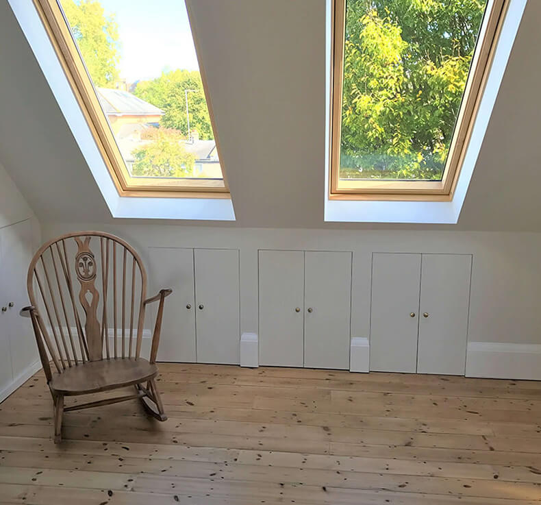 bedroom lounge area with skylight and wooden floorboards