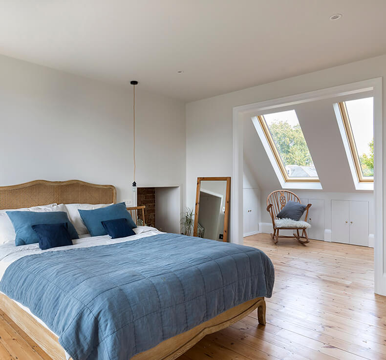 wooden floored bedroom with skylight and nook