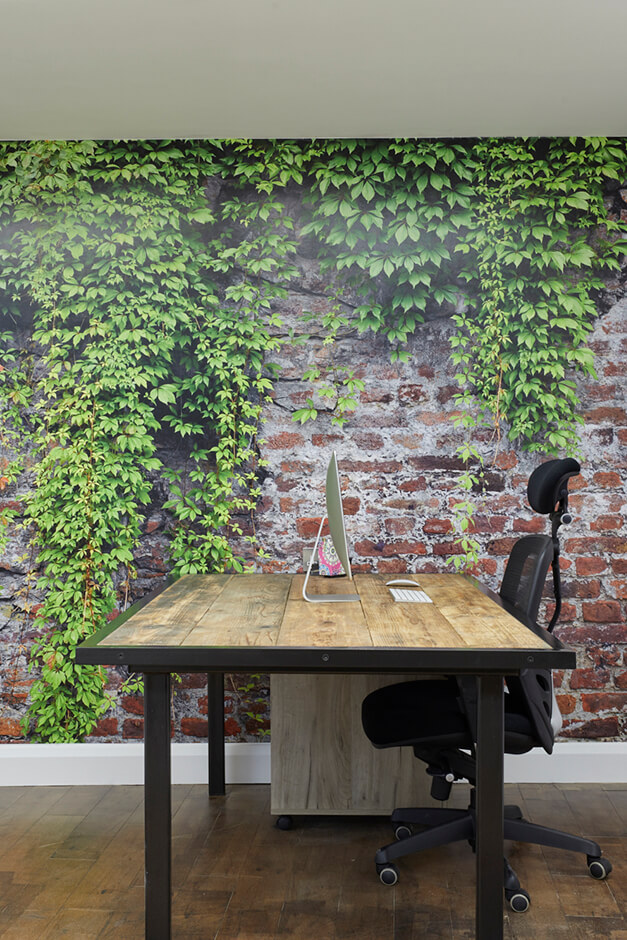 office with wooden desk with red brick wall paper and wooden flooring