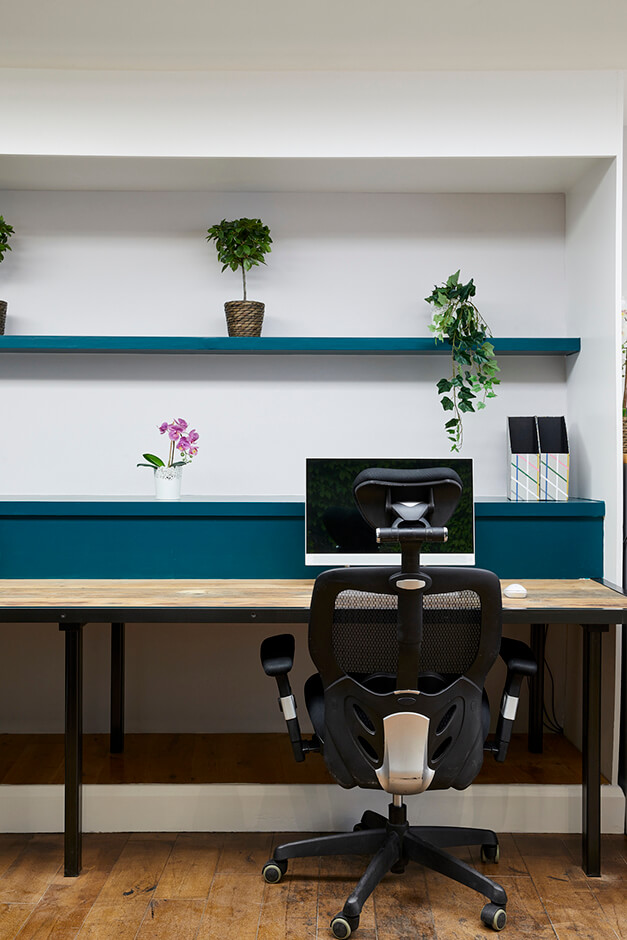 simple office with white walls and blue display cabinets
