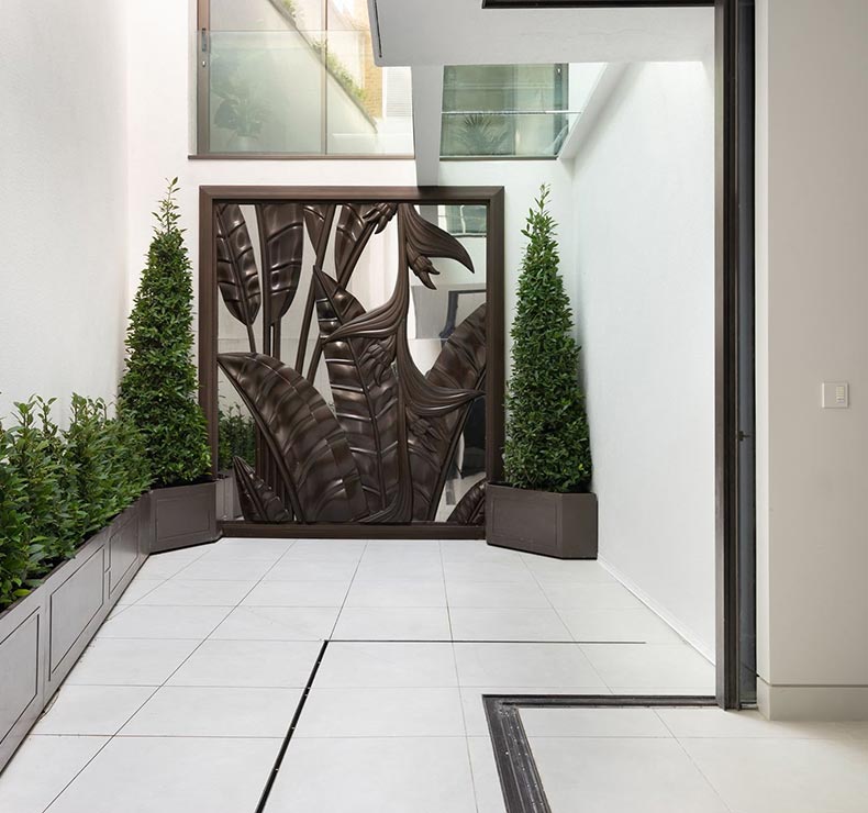 minimalist sunroom with skylight, white tiles, white walls and house plants