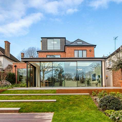 double storey home extension with large windows and open plan kitchen